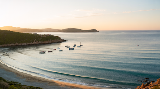 Peaceful view of Turkish coastline at sunset with turquoise water and anchored boats.