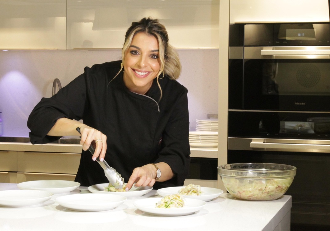 Samira Ardalan preparing a Mediterranean dish in a Miele kitchen